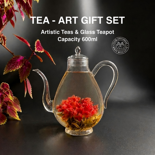 Glass teapot with floral elements on a dark background, labeled as a tea art gift set.